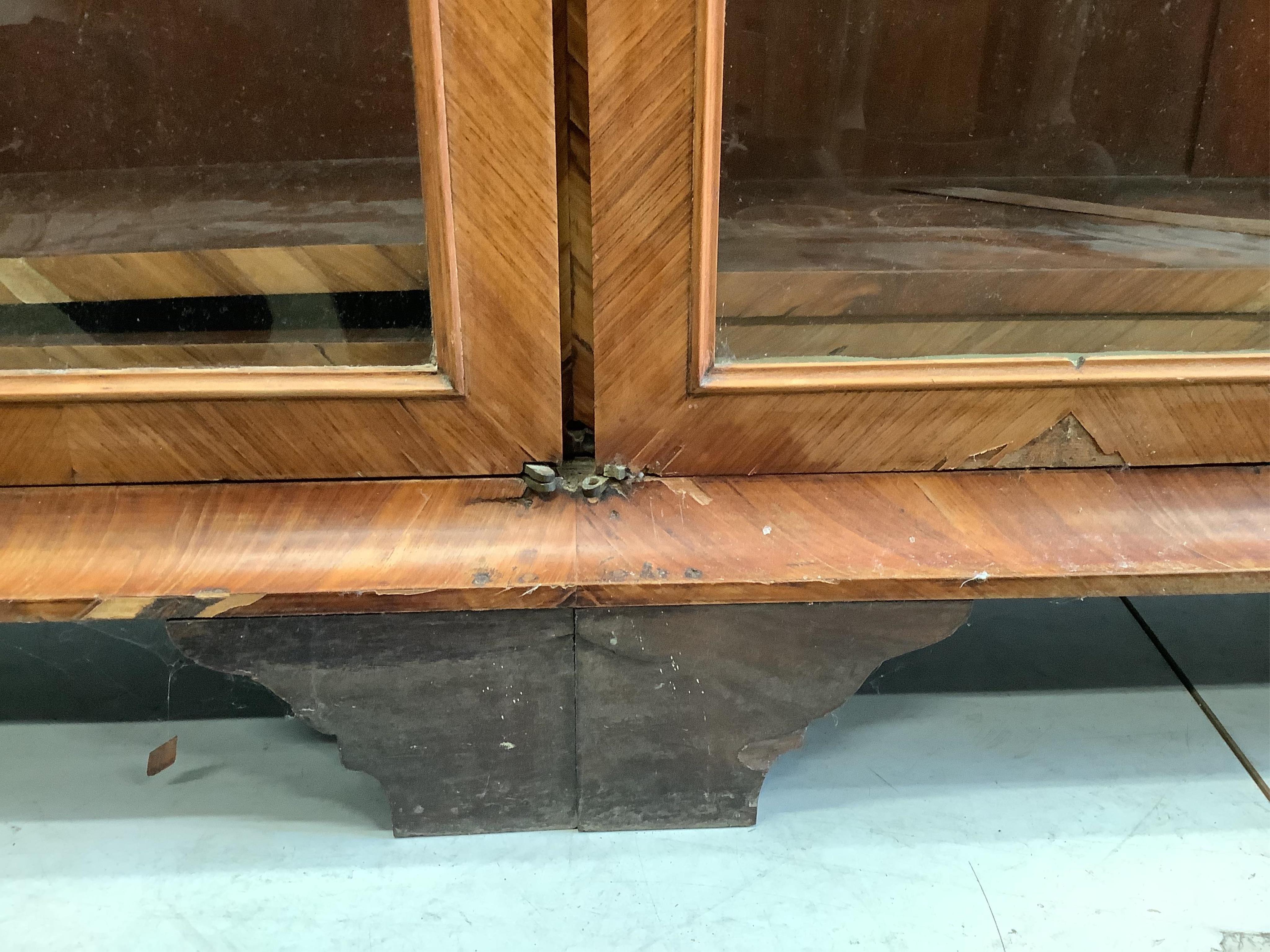 A large 19th century glazed kingwood bookcase, fitted four hinged doors and three adjustable shelves, width 190cm, depth 36cm, height 145cm. Condition - poor